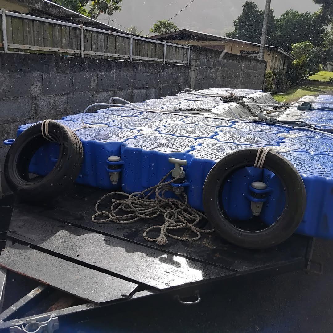 Dock flottant chargé sur une remorque avec pneus de protection